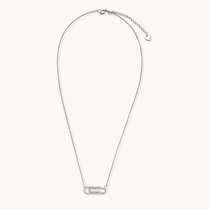 White gold plated necklace with dual-frame geometric pendant featuring crystal pavé border on pale background.